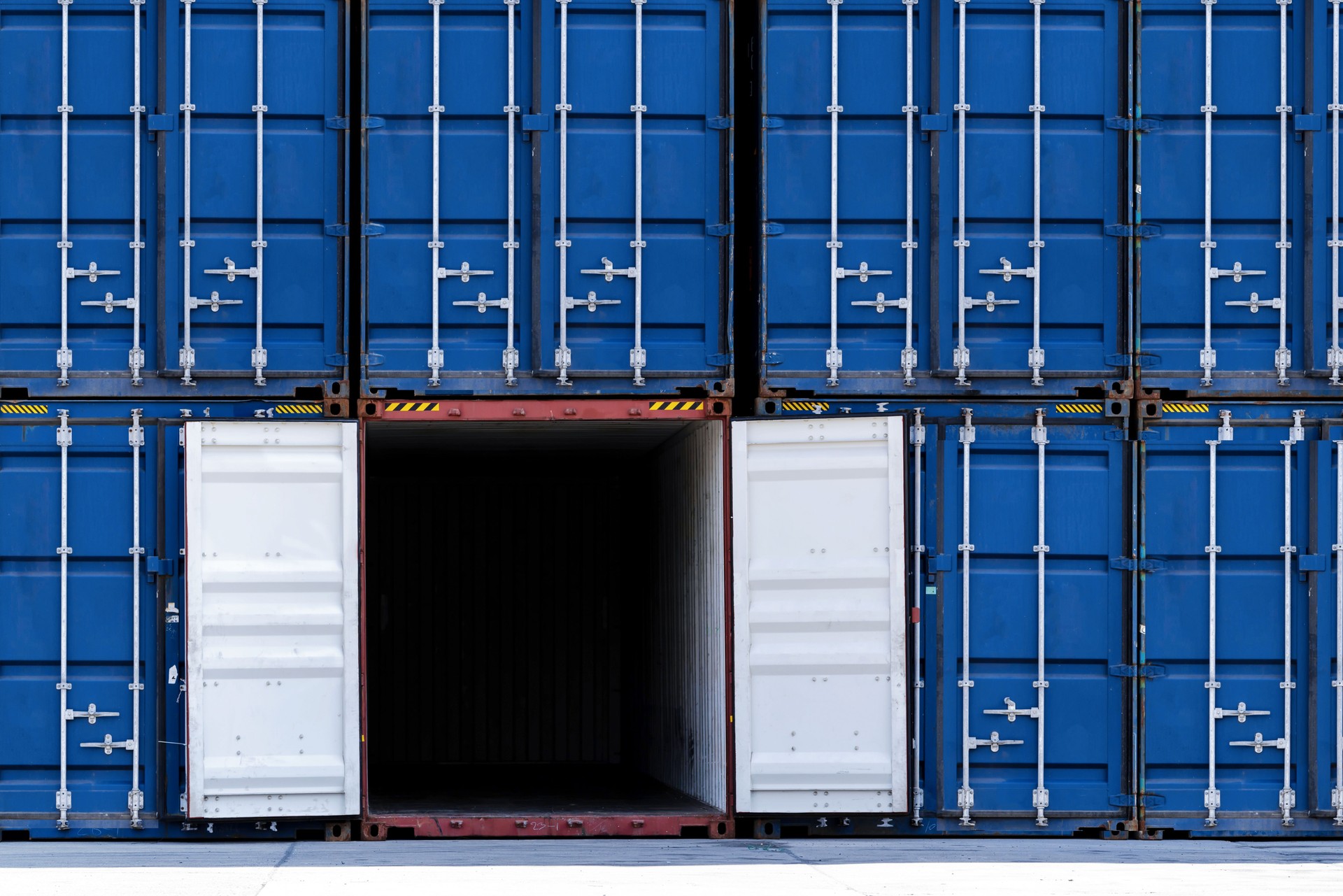 Stack of cargo containers at cargo port ship yard storage. Row of container for import and export distributor warehouse. Logistic and transportation industrial